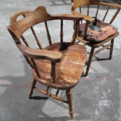 Two vintage wooden colonial-style captain's armchairs