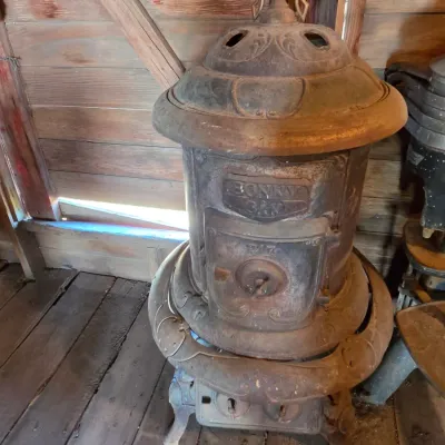 Antique cast-iron "oak-style" pot-belly stove, which reads "BONNY OAK" on the upper front door - appears complete and...