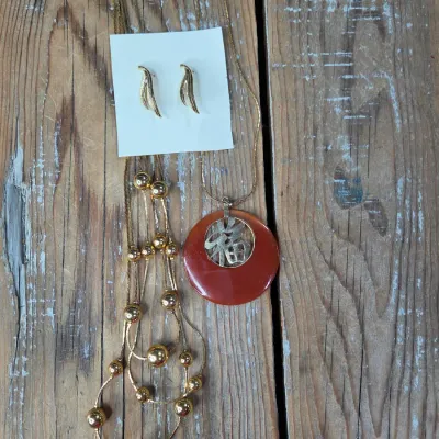 Good fortune necklace with 3 strand gold toned beaded necklace. and a pair of earrings