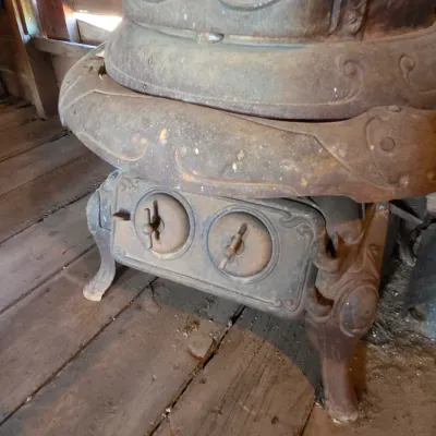 Antique cast-iron "oak-style" pot-belly stove, which reads "BONNY OAK" on the upper front door - appears complete and...