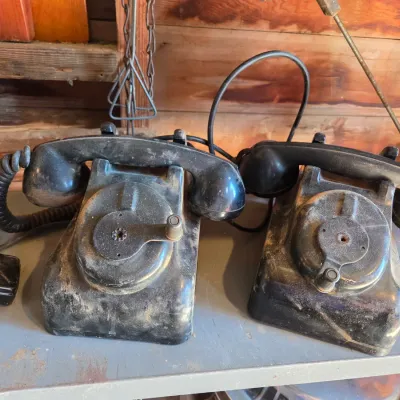 Two Leich Model 901B vintage black Bakelite desk telephones with a hand crank, 1930s or 1940s