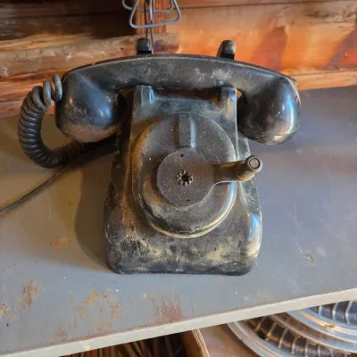Two Leich Model 901B vintage black Bakelite desk telephones with a hand crank, 1930s or 1940s