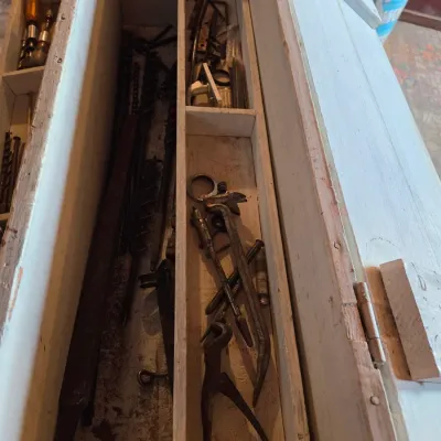 Vintage wood crate toolbox with drawer and an assortment of old tools