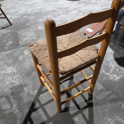Vintage light wood ladder-back chair with a traditional woven rush seat