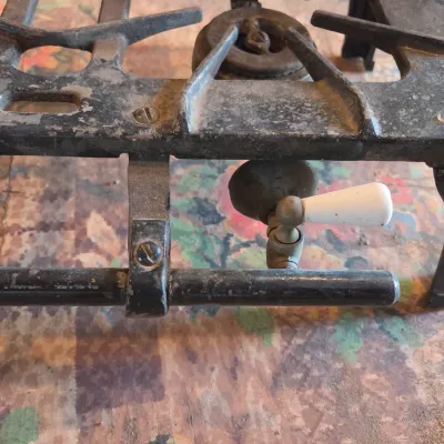 Vintage cast-iron three-burner camp stove with porcelain handles marked 137 on bottom Possibly a Griswold?