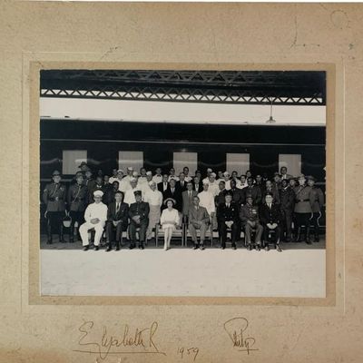 Group photograph of her Majestry Queen Elizabeth II and Phillip w/ her train entourage, autographed below.  Pictures 3 thru 12 are being...