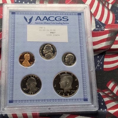 Sale Photo Thumbnail #23: 1987-S United States Mint Proof Set In AACGS PR 67 Holder, Cent has Edge Corrosion