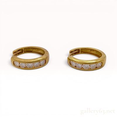 Sale Photo Thumbnail #504: A Pair of 18 Karat Yellow Gold and Diamond Channel-Set Huggie Hoop Earrings