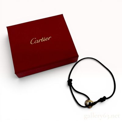Sale Photo Thumbnail #329: A Cartier Tri-Color 18 Karat Gold Trinity Cord Bracelet