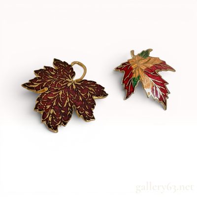 Sale Photo Thumbnail #319: Two Metropolitan Museum of Art MMA Gold-Tone and Enamel Maple Leaf Brooches