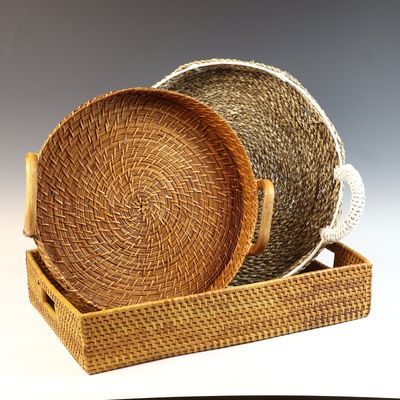A Trio of Decorative Woven Rattan and Seagrass Trays and Baskets