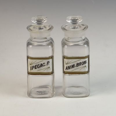 A Pair of Whitall Tatum and Company Glass Apothecary Bottles