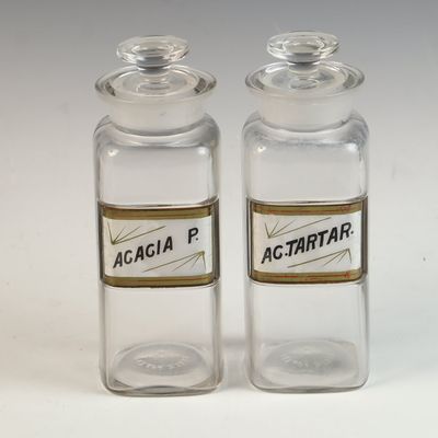 A Pair of Whitall Tatum and Company Glass Apothecary Jars with Vitrified Labels