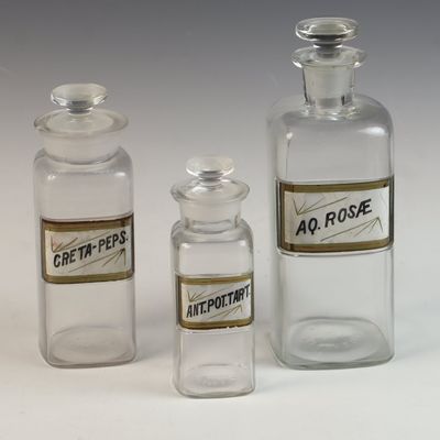 A Trio of Antique Whitall Tatum and Company Glass Apothecary Bottles