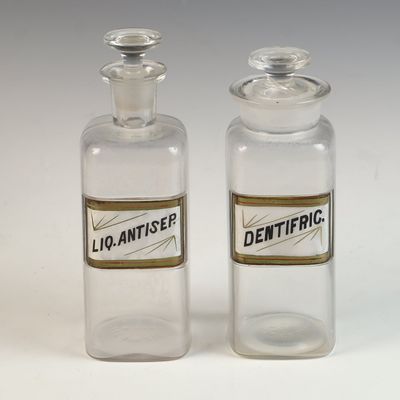 A Pair of Whitall Tatum and Company Clear Glass Label Under Glass Apothecary Bottles