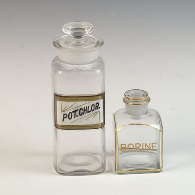A Pair of American Antique Stoppered Clear Glass Apothecary Bottles