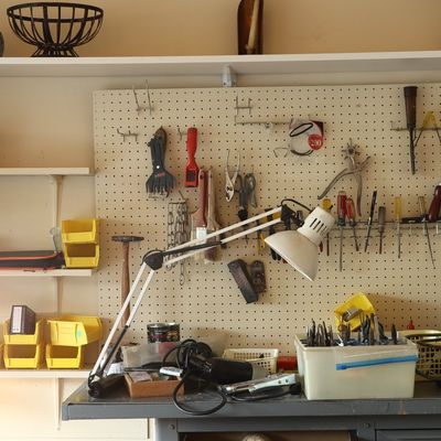 A Collection of Workshop Tools, Organizational Equipment, and a Craftsman Workbench