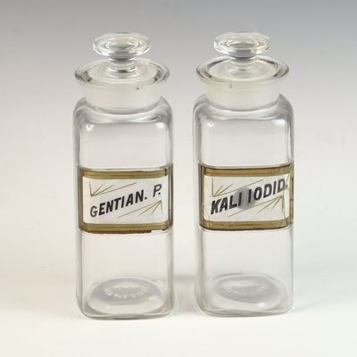 A Pair of W.T. Co. Glass Apothecary Bottles