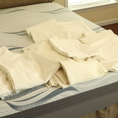 A Set of Fourteen Cotton Curtain Panels in Off-White