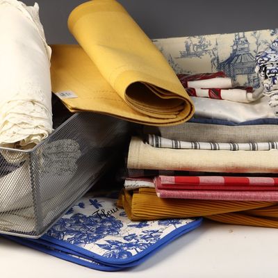 An Assortment of Household Textiles in a Wire Mesh Basket