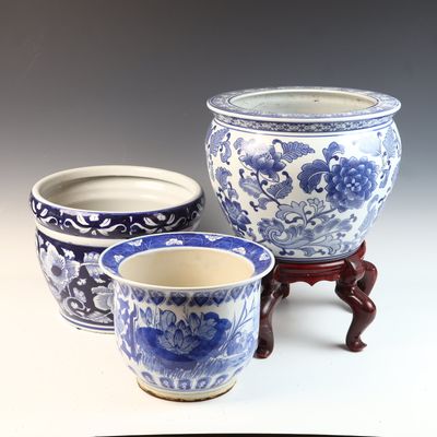 A Trio of Chinese Style Blue and White Porcelain Planters with a Wooden Stand