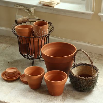 An Assortment of Terracotta Garden Planters and Decorative Baskets
