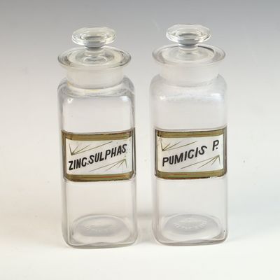 A Pair of Whitall Tatum Co. Glass Apothecary Shop Rounds with Under-Glass Labels