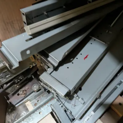 Sale Photo Thumbnail #109: Assorted metal server rack rails and mounting hardware, showing some wear and dust from storage.