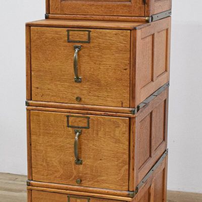 Sale Photo Thumbnail #411: A Modular Four-Section Oak Filing Cabinet and Footstool