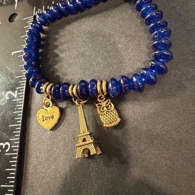Dark blue beaded gold tone charm stretch bracelet