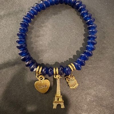Dark blue beaded gold tone charm stretch bracelet