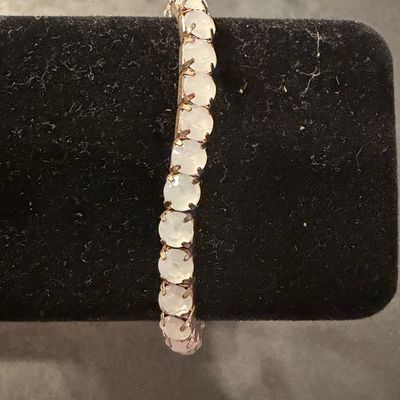 copper-toned stretch bracelet featuring a continuous line of bezel-set, milky cabochon stones. Type