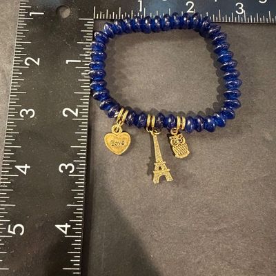 Dark blue beaded gold tone charm stretch bracelet