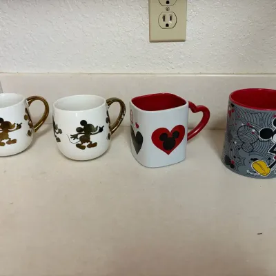 Several Disney Mickey Mouse Themed Coffee Mugs