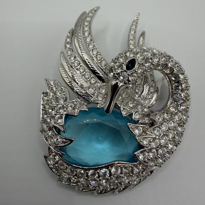 Silver Tone Nolan Miller Crystal Swan Brooch with Blue Cabochon Center Accent