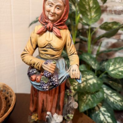 Vintage peasant woman figurine with fruit basket