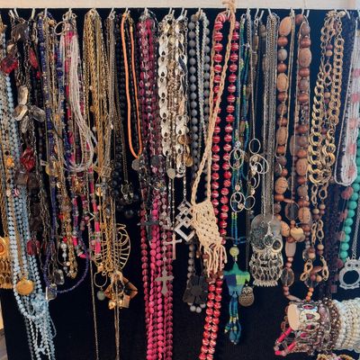 Beaded and chain necklaces on display, owl pendant