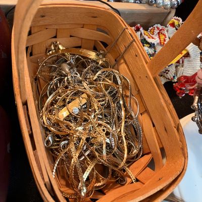 Basket of gold tone chains and necklaces