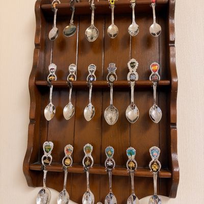 Souvenir spoon collection in wood display rack