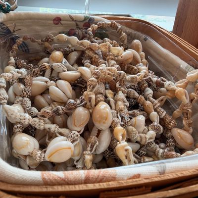 Cowrie shell necklaces in woven basket