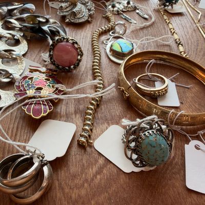 Gold tone bangles, hoop earrings, turquoise ring