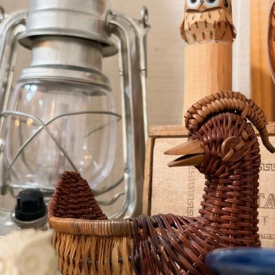 Vintage metal hurricane lantern and wicker goose basket