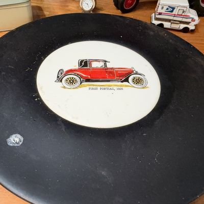 Black plate with antique red car graphic
