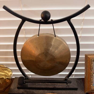 Brass tabletop gong on iron stand