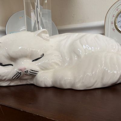 White ceramic sleeping cat figurine