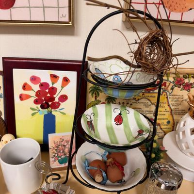 Tiered metal stand, painted ceramic bowls, floral art print
