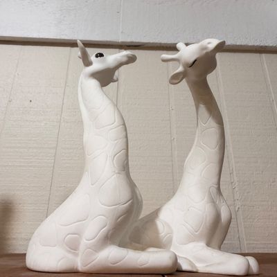 White ceramic giraffe figurines, pair