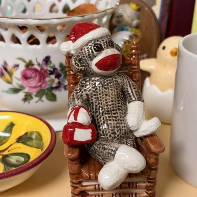 Ceramic sock monkey Santa figurine in rocker