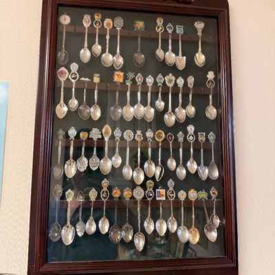 Souvenir spoon collection in glass front display case