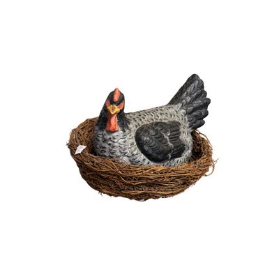 Large vintage ceramic hen figurine on nest.